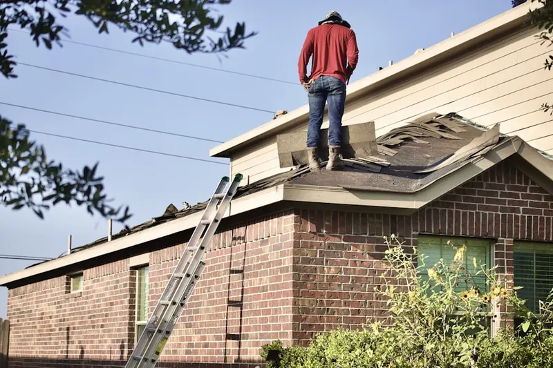 Professional roofer working on a residential roof in Lexington Glen